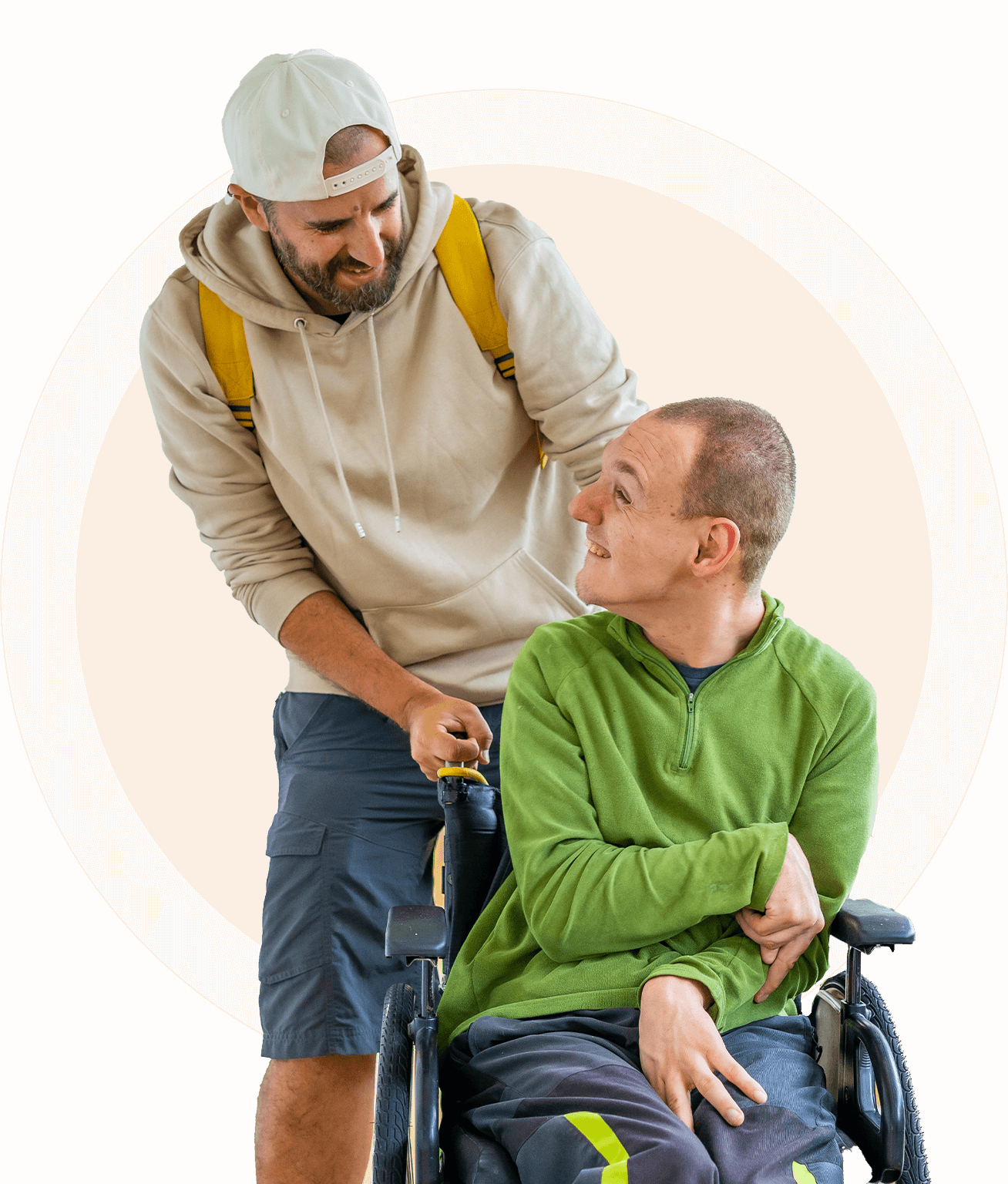 04 A person in a beige hoodie and shorts assists a person in a green shirt sitting in a wheelchair. They are both smiling against an orange background.